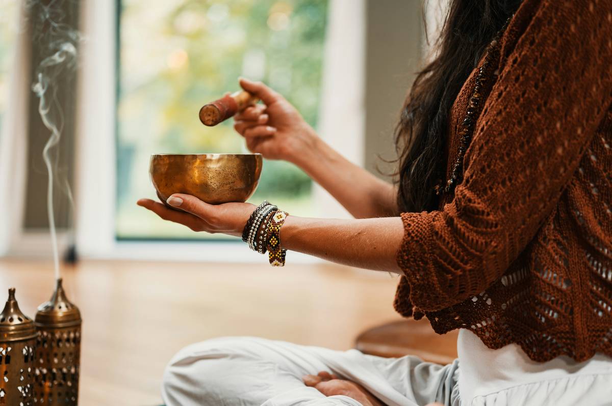 Ancient ayurveda practitioner preparing herbal weight loss remedies in clay bowls